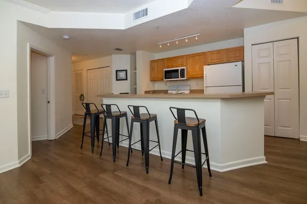 a group of chairs sitting in a kitchen and dining room