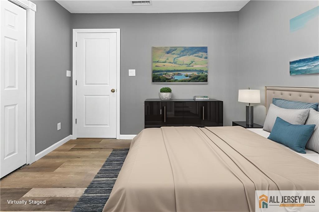 4 Burnham Road East Brunswick, NJ 08816 - Photo 12 of 25 a bedroom with a bed and painting on the wall