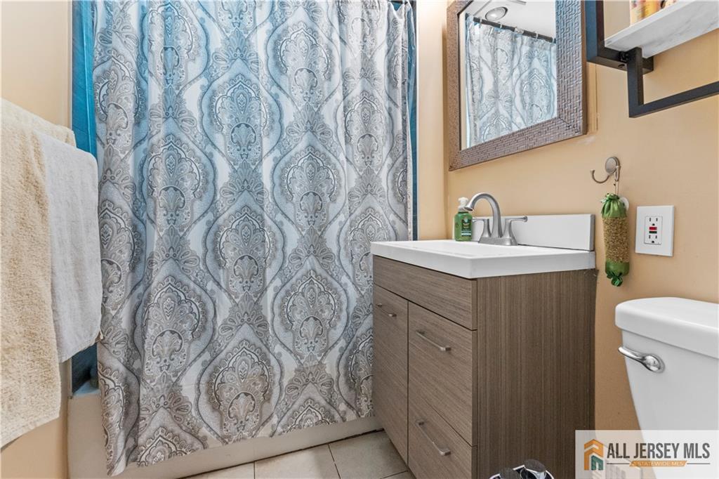 4 Burnham Road East Brunswick, NJ 08816 - Photo 16 of 25 a bathroom with a sink and mirror with toilet