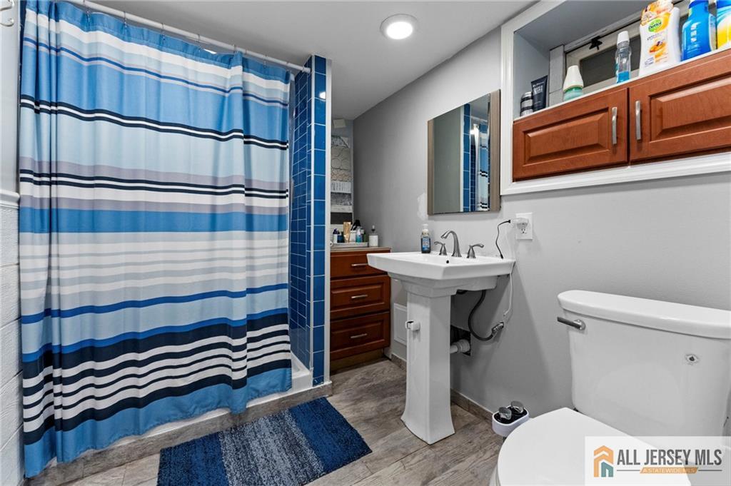 4 Burnham Road East Brunswick, NJ 08816 - Photo 19 of 25 a bathroom with a sink a toilet and shower