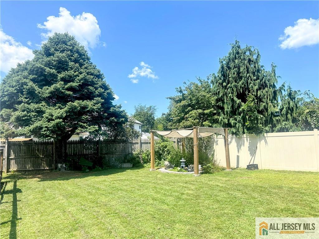 4 Burnham Road East Brunswick, NJ 08816 - Photo 22 of 25 a backyard of a house with lots of green space and fountain