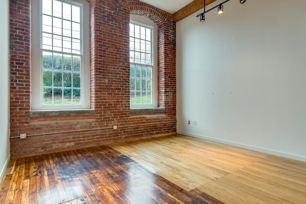 1350 Rosa L Parks Boulevard, Unit 239 Nashville, TN 37208 - Photo 4 of 23 an empty room with wooden floor and windows