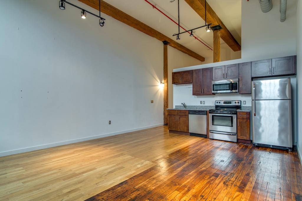 1350 Rosa L Parks Boulevard, Unit 239 Nashville, TN 37208 - Photo 7 of 23 a kitchen with stainless steel appliances a refrigerator and a stove top oven