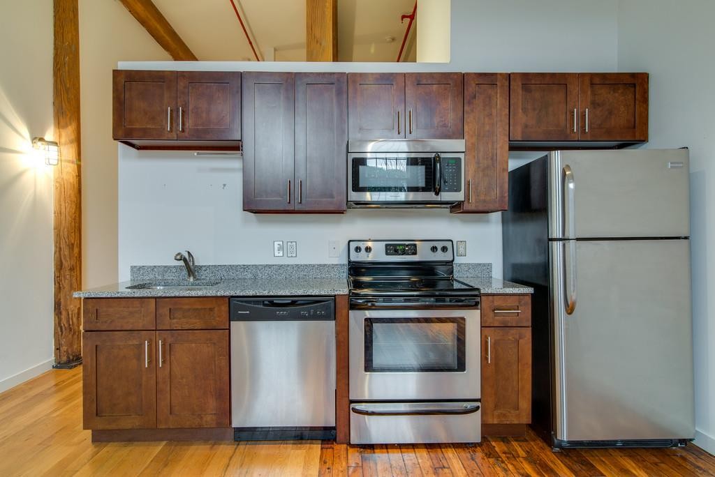 1350 Rosa L Parks Boulevard, Unit 239 Nashville, TN 37208 - Photo 8 of 23 a kitchen with a stove and a refrigerator