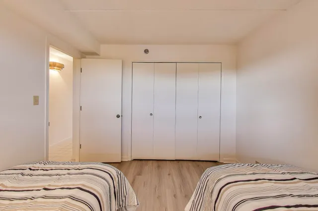 a view of bedroom with a bed and wooden floor