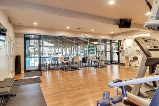 a room with lots of wooden furniture and windows