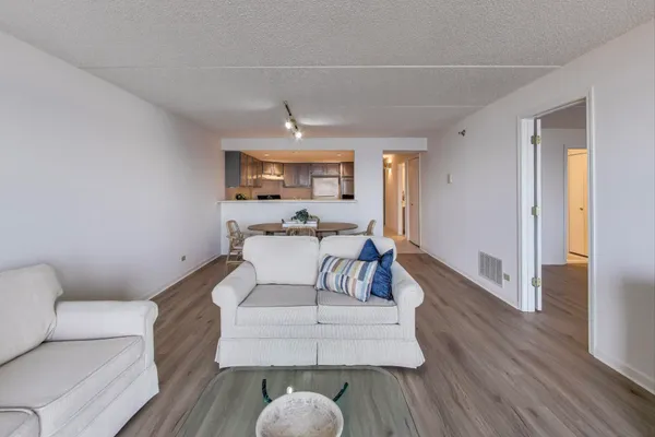 a living room with furniture and a wooden floor