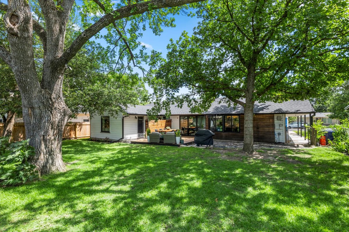 1414 Ridgemont Drive Austin, TX 78723 - Photo 1 of 1 Back of property with an outdoor living space and a patio area