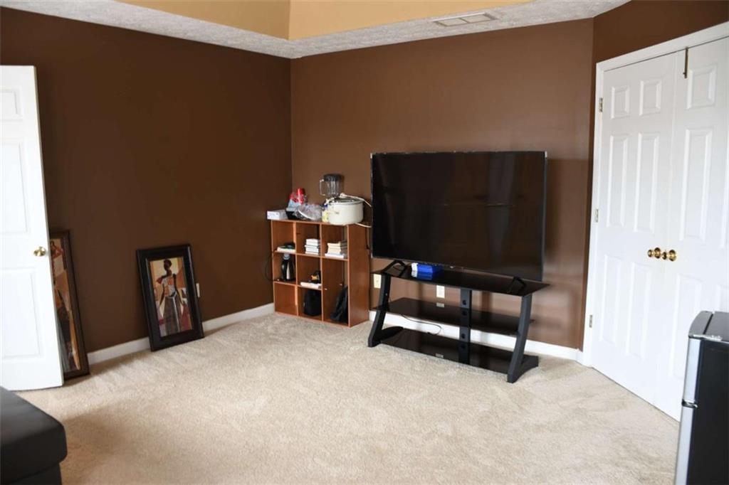 355 Magnolia Walk Lane Atlanta, GA 30349 - Photo 14 of 27 a bedroom with a bed and a flat screen tv