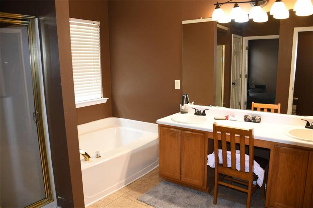 355 Magnolia Walk Lane Atlanta, GA 30349 - Photo 17 of 27 a bathroom with a sink and a mirror