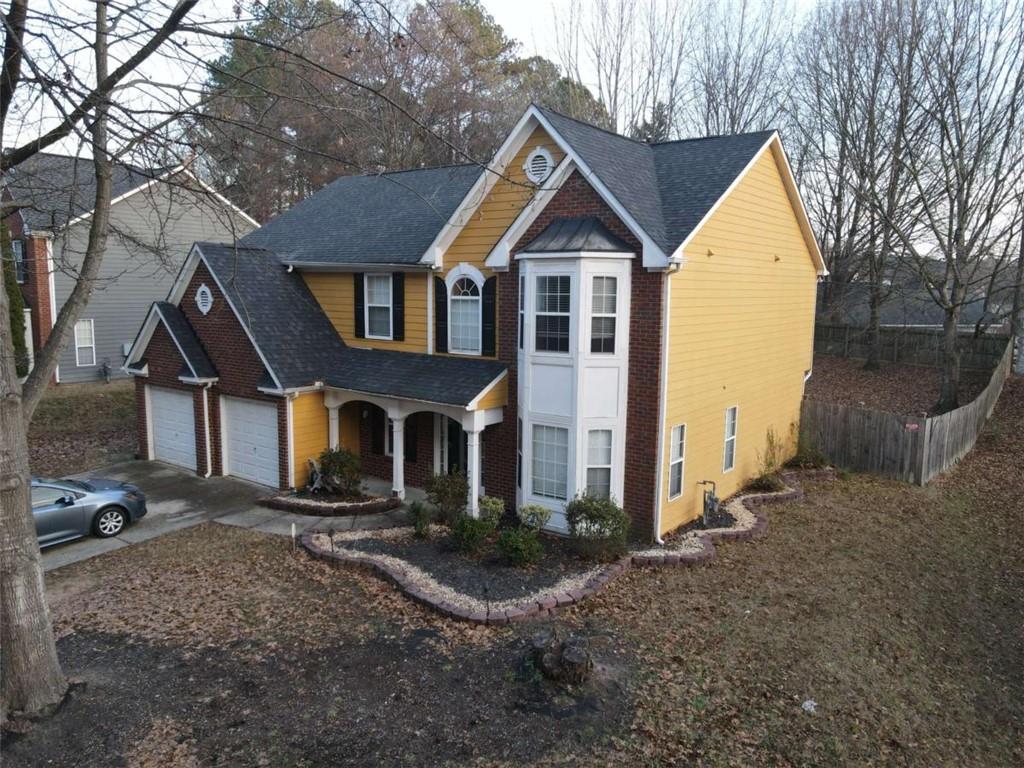 355 Magnolia Walk Lane Atlanta, GA 30349 - Photo 2 of 27 a front view of a house with a yard