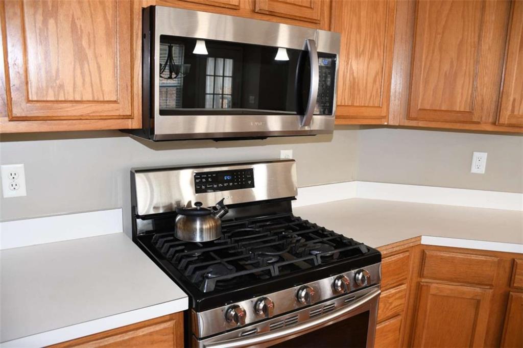 355 Magnolia Walk Lane Atlanta, GA 30349 - Photo 5 of 27 a stove top oven sitting inside of a kitchen