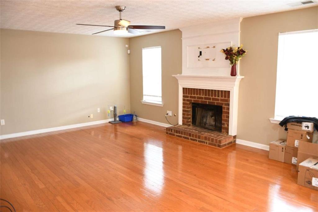 355 Magnolia Walk Lane Atlanta, GA 30349 - Photo 8 of 27 a view of empty room with a fireplace and fan