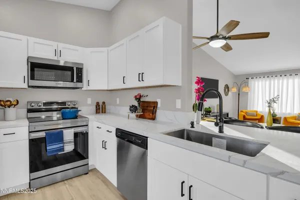 a kitchen with a sink cabinets and stainless steel appliances