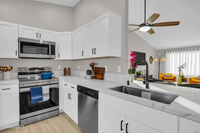 a kitchen with a sink cabinets and stainless steel appliances