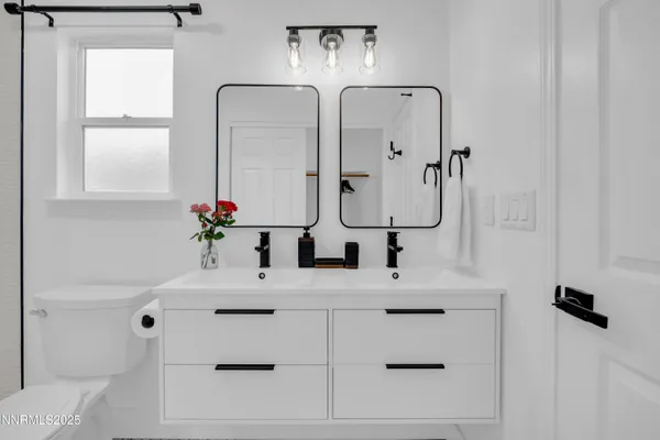 a bathroom with a sink vanity and a mirror