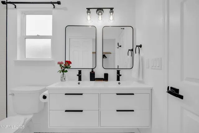 a bathroom with a sink vanity and a mirror