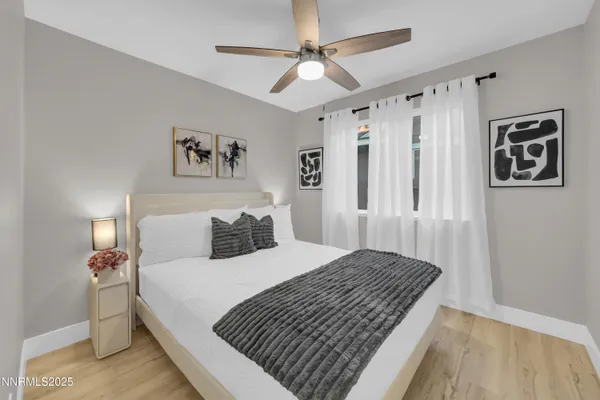 a bedroom with a large bed and a chandelier
