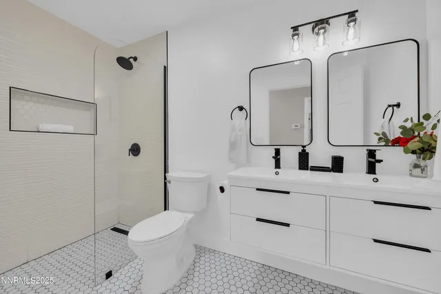 a bathroom with a sink a toilet and shower