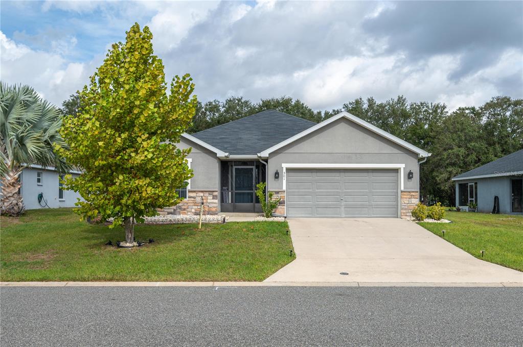a front view of a house with a yard and garage