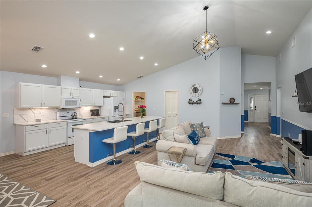 501 Interlock Street Lake Alfred, FL 33850 - Photo 11 of 35 a living room with kitchen island furniture and a kitchen view