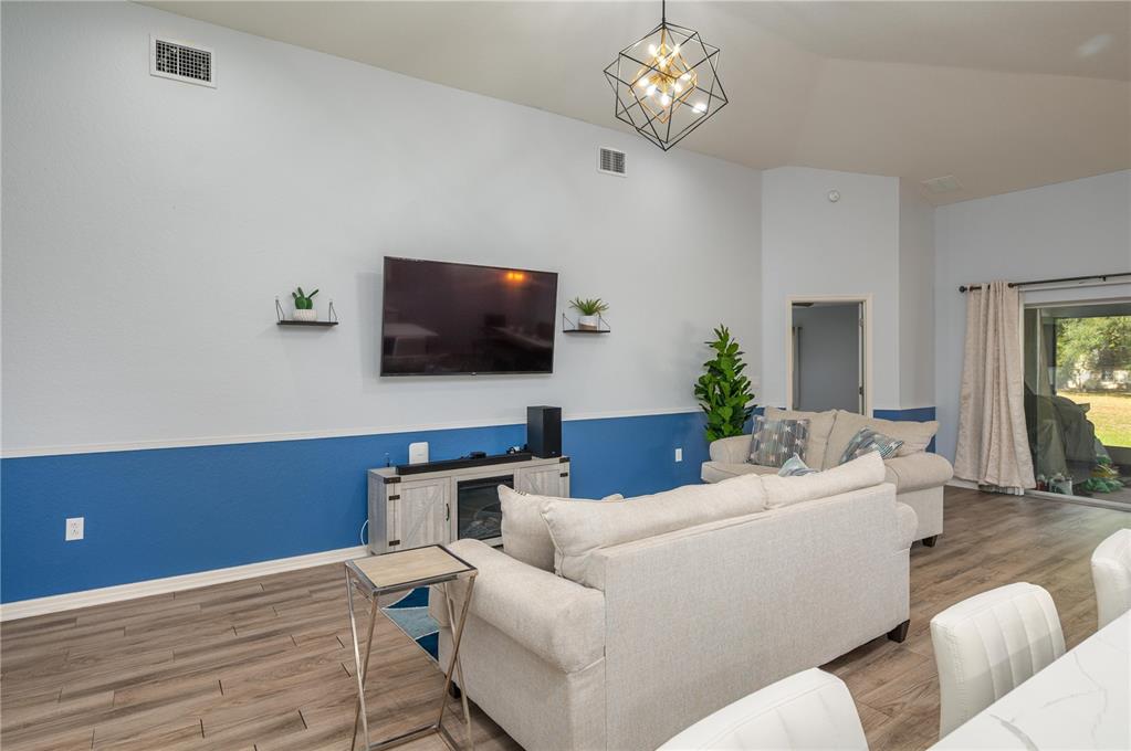 501 Interlock Street Lake Alfred, FL 33850 - Photo 14 of 35 a living room with furniture and a flat screen tv