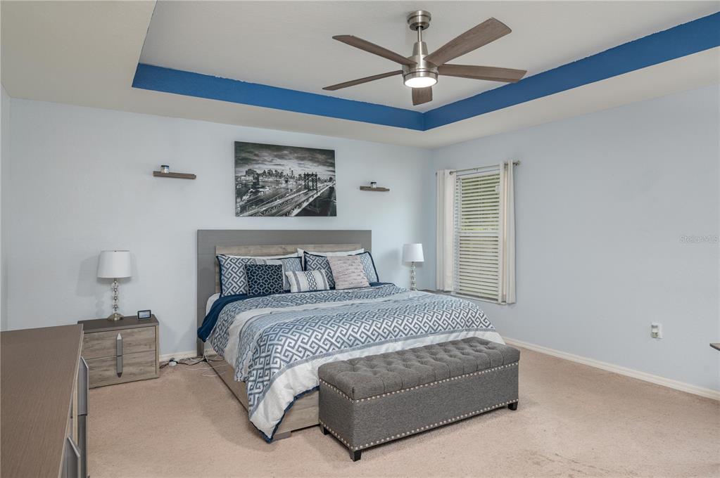 501 Interlock Street Lake Alfred, FL 33850 - Photo 20 of 35 a bedroom with a large bed chandelier and a window