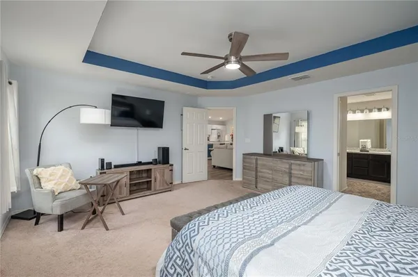 a bedroom with furniture and a flat screen tv