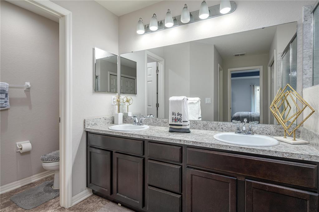 501 Interlock Street Lake Alfred, FL 33850 - Photo 23 of 35 a bathroom with a double vanity sink and a mirror