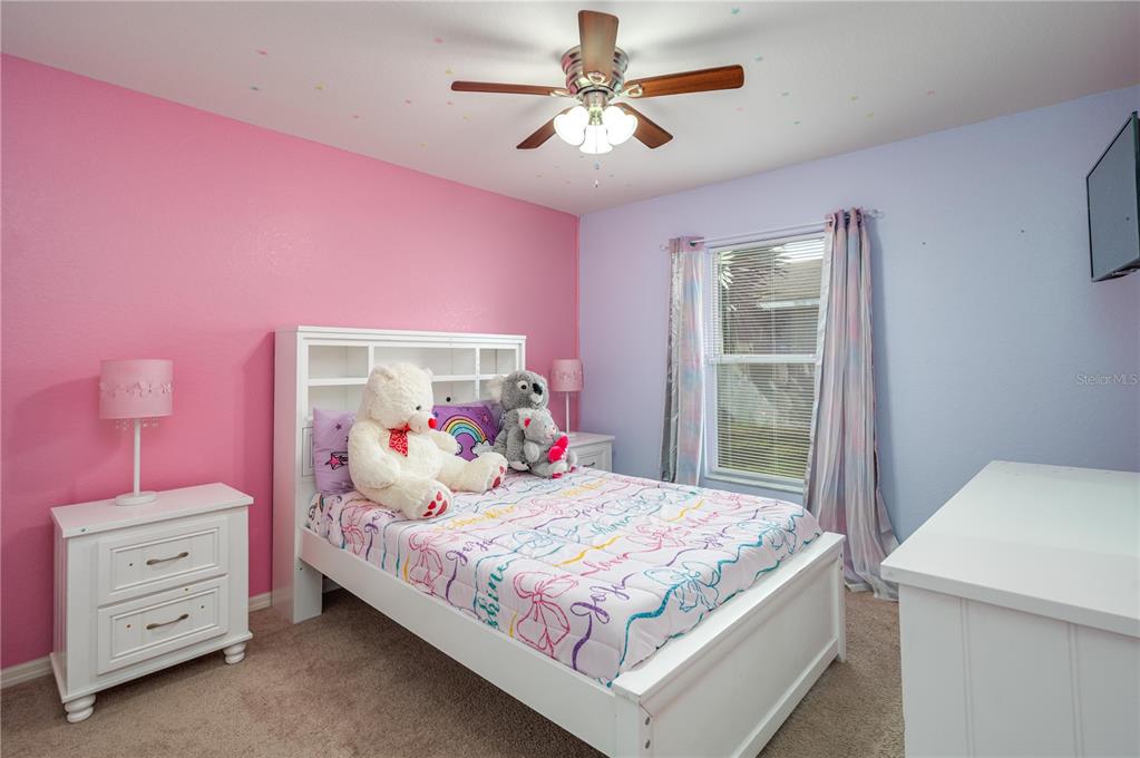 501 Interlock Street Lake Alfred, FL 33850 - Photo 25 of 35 a bedroom with a bed and a chandelier