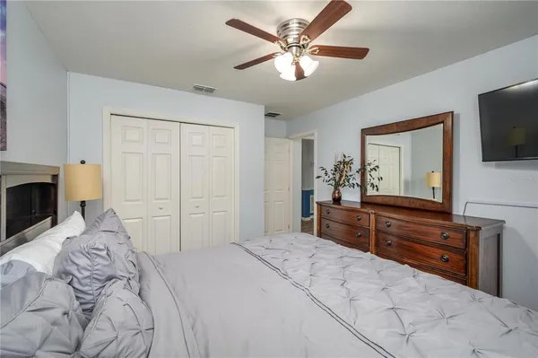 a bedroom with a bed and a television