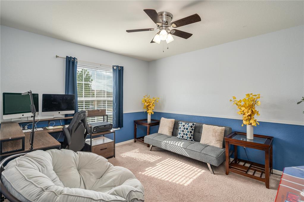 501 Interlock Street Lake Alfred, FL 33850 - Photo 8 of 35 a living room with furniture and a flat screen tv