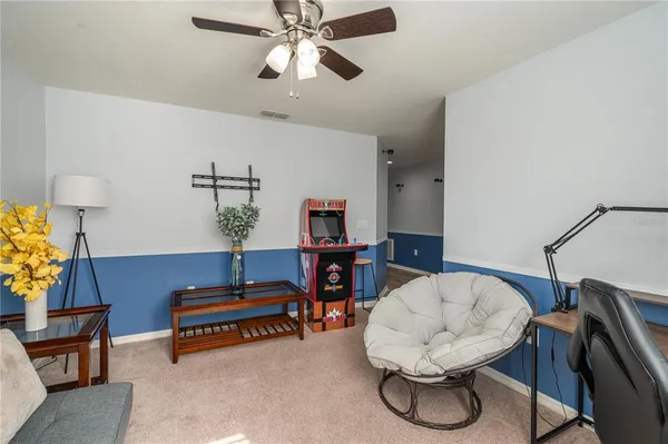 a living room with furniture and a lamp