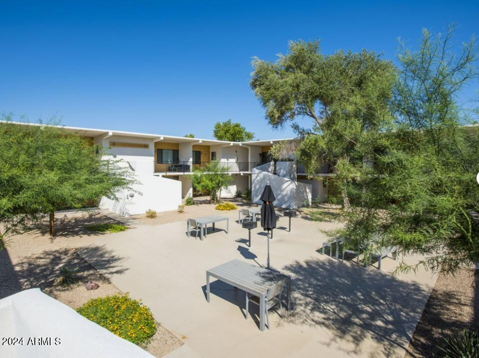 8021 East Osborn Road, Unit 1A Scottsdale, AZ 85251 - Photo 1 of 10 a view of a backyard house and swimming pool