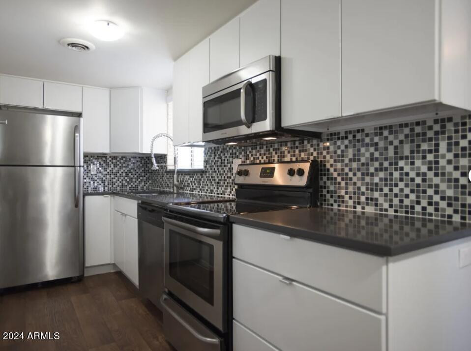 8021 East Osborn Road, Unit 1A Scottsdale, AZ 85251 - Photo 3 of 10 a kitchen with granite countertop a sink stove and refrigerator