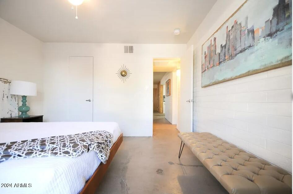 8021 East Osborn Road, Unit 1A Scottsdale, AZ 85251 - Photo 5 of 10 a bedroom with a bed and a painting on the wall