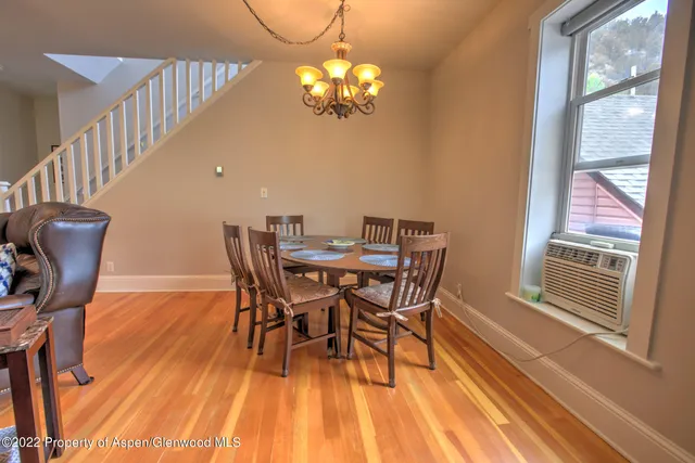 a view of a dining room with furniture wooden floor and chandelier