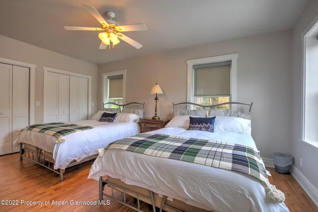 a bedroom with two beds and a chandelier