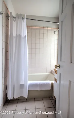 a bathroom with a bathtub and shower
