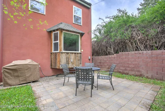 a view of a patio with table and chairs and potted plants