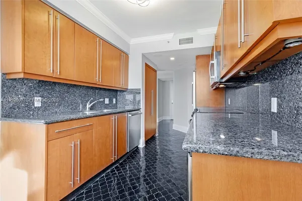 a view of a kitchen with granite countertop cabinets