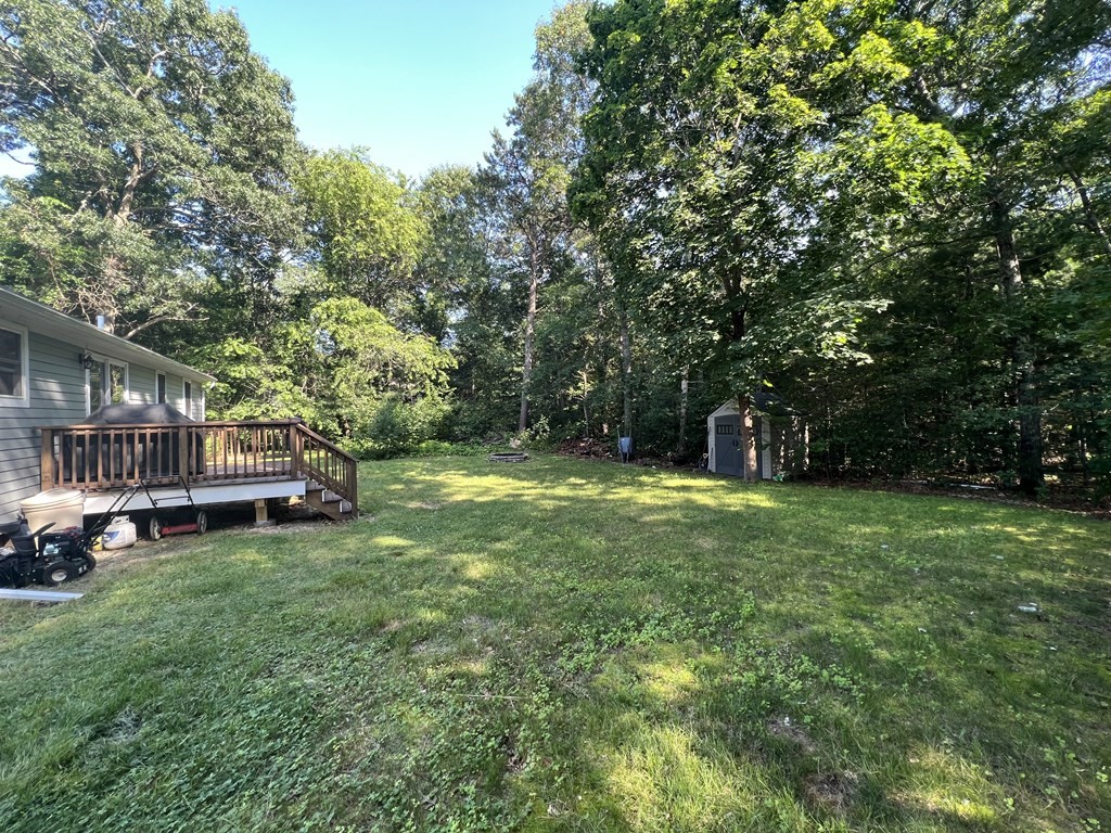 66 Carver Road Plymouth, MA 02360 - Photo 4 of 21 a view of a house with a big yard and large trees