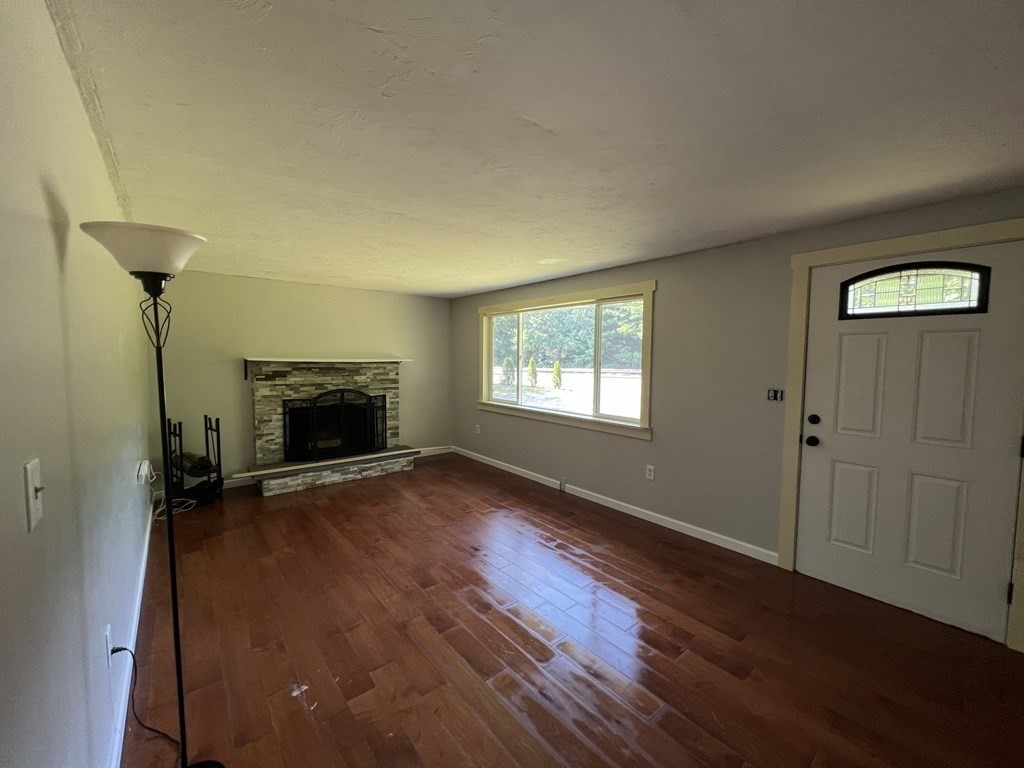 66 Carver Road Plymouth, MA 02360 - Photo 10 of 21 a view of empty room with fireplace and wooden floor