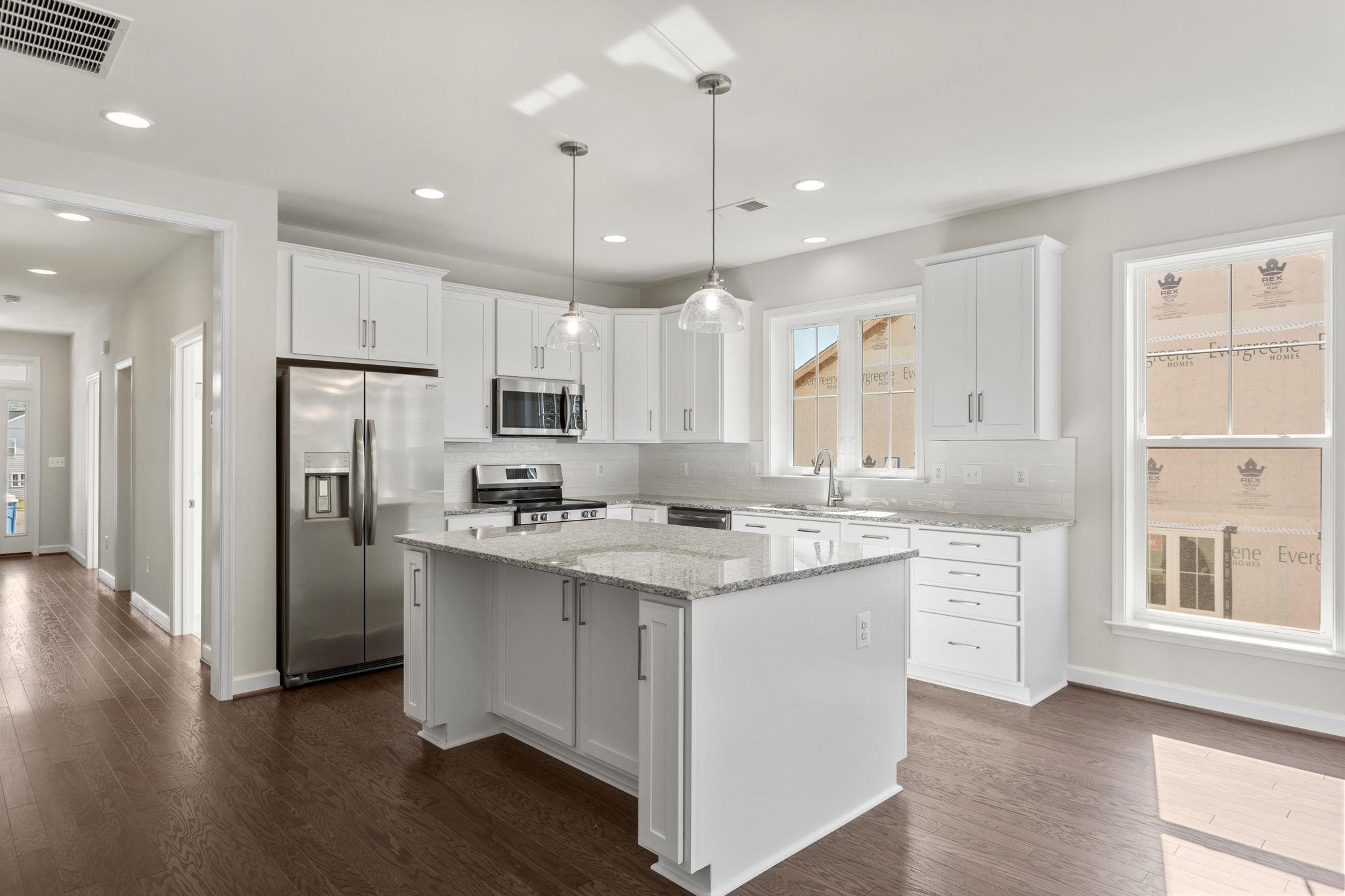 2784 Rutlege Road, Unit 188 Harrisonburg, VA 22801 - Photo 26 of 30 a kitchen with stainless steel appliances granite countertop a refrigerator a sink dishwasher a oven and a dining table with wooden floor
