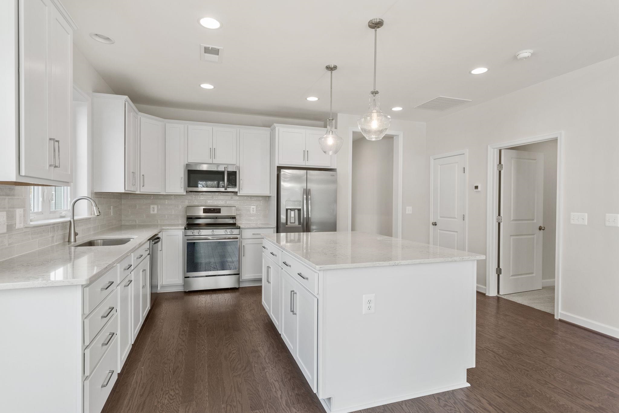 2784 Rutlege Road, Unit 188 Harrisonburg, VA 22801 - Photo 5 of 31 a white kitchen with a sink a stove oven a refrigerator with white cabinets and wooden floor