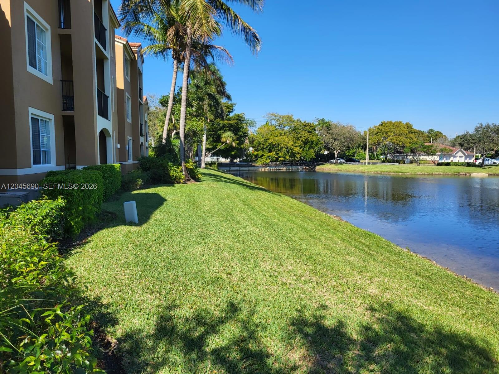 8070 North Nob Hill Road, Unit 208 Tamarac, FL 33321 - Photo 13 of 16 a view of a lake with houses in the back