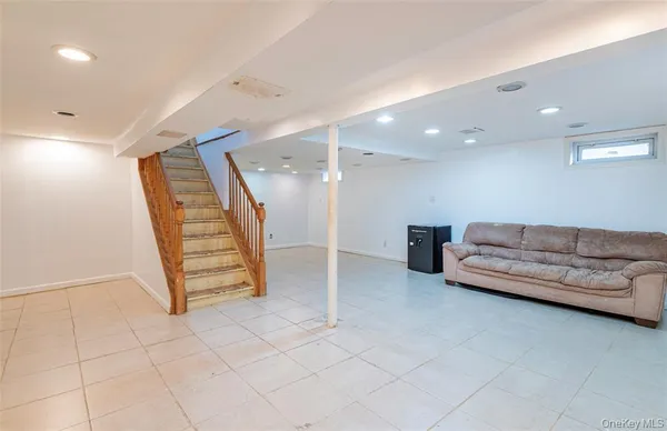 a living room with furniture and a ceiling fan