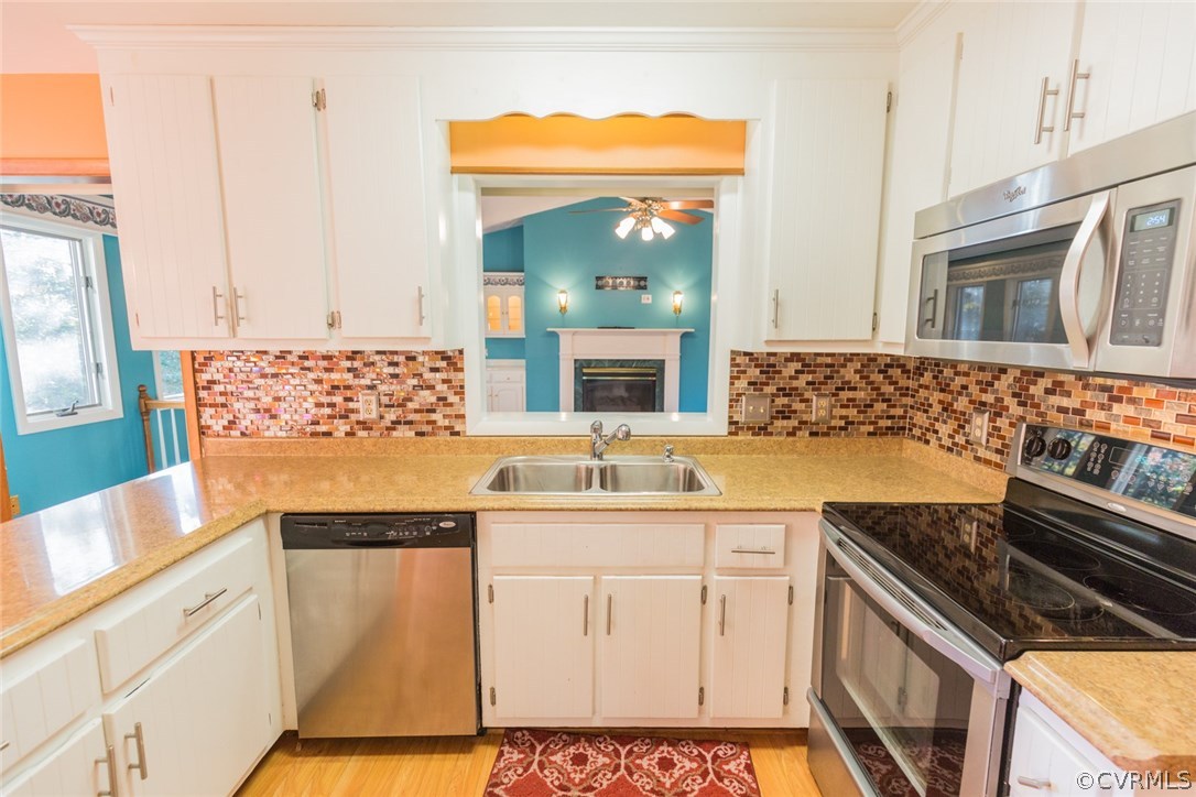 13601 Winterberry Ridge Midlothian, VA 23112 - Photo 25 of 43 a kitchen with stainless steel appliances a sink stove and cabinets