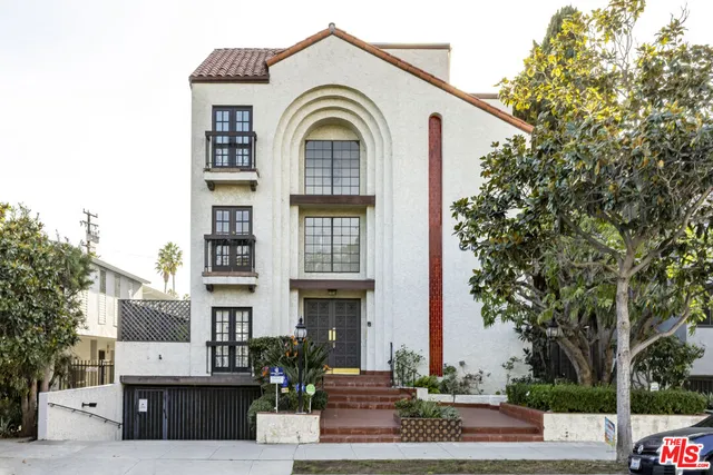 a front view of a residential houses with yard