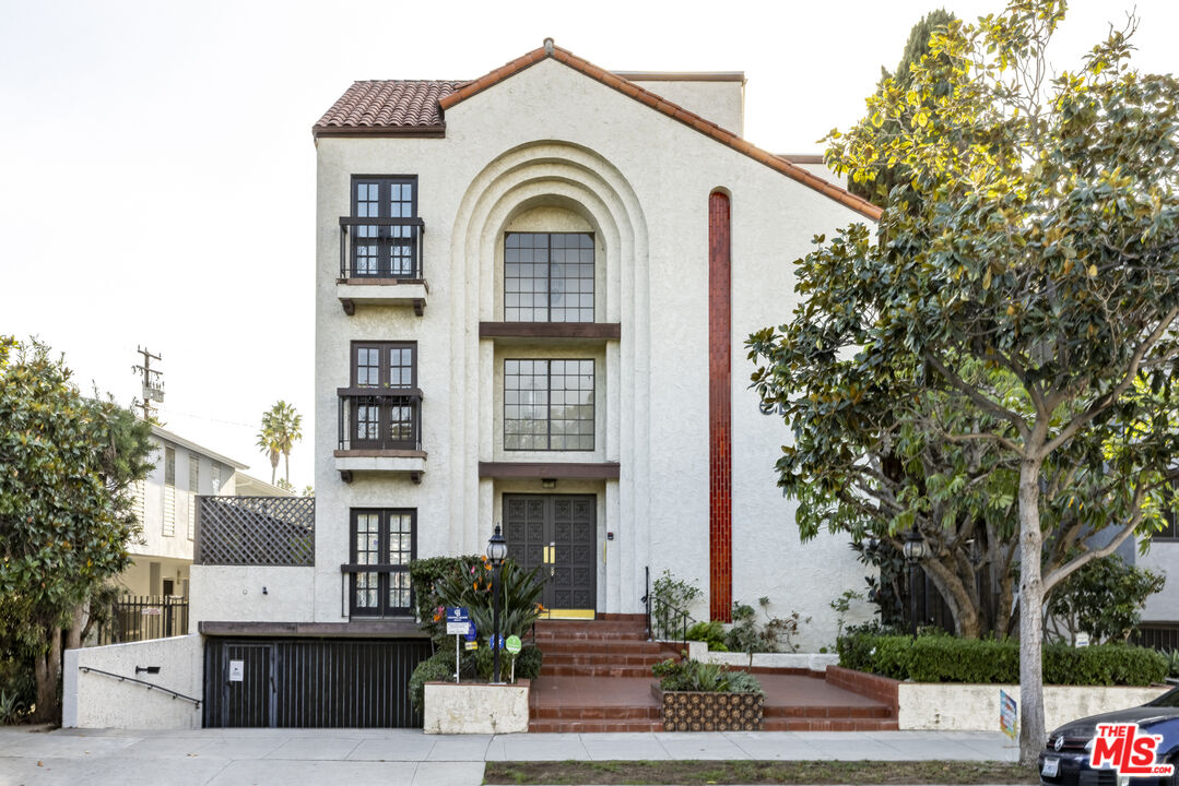 a front view of a residential houses with yard